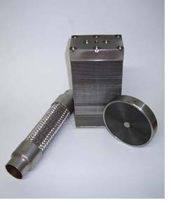 Left to right: A stainless steel flame arrestor, a corrugated stainless steel exhaust flex, a stainless steel final flame trap element and a stainless steel flame arrestor.